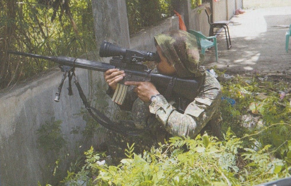 A Marine sniper positions himself to get the best shot against rogue MNLF