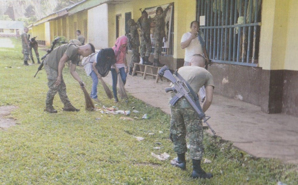 Marine personnel cleaning school premises as part of Brigada Eskwela