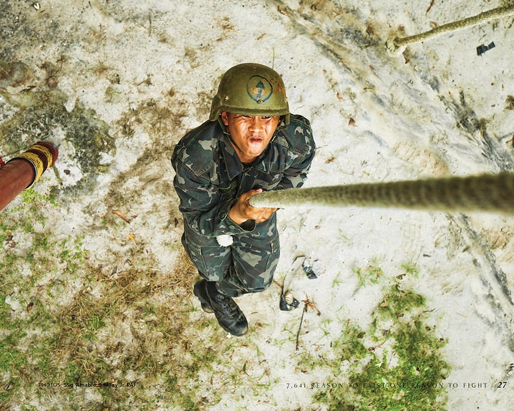 Marine candidate grabing a rope