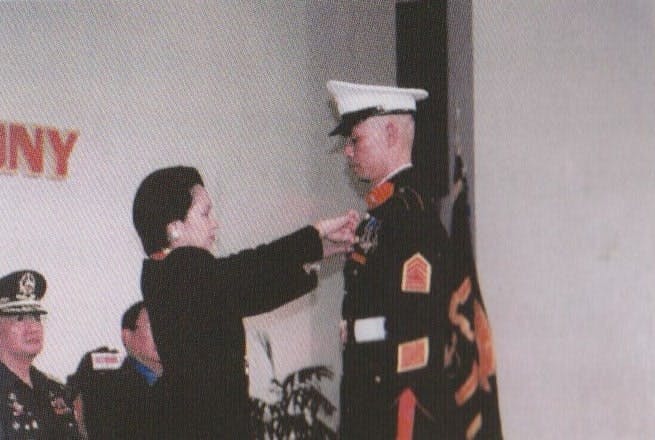 Displaying President Gloria Arroyo awards the distinguished Marines and the wife of a Marine who died in a combat ops