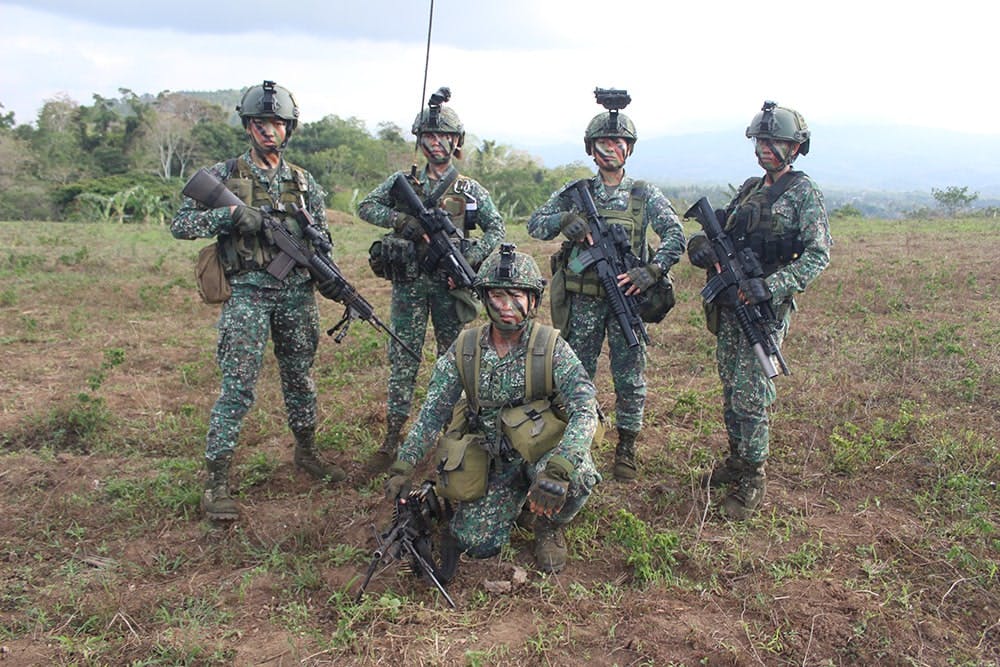 Female Marines in full combat gear